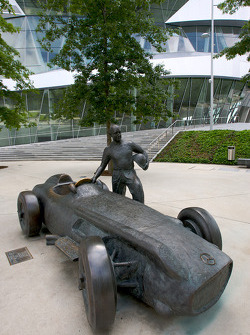 A bronze statue of Juan Manuel Fangio and his Mercedes-Benz W196
