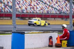 A speedway safety worker waits for track drying to finish