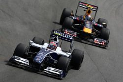 Kazuki Nakajima, Williams F1 Team leads Sebastian Vettel, Red Bull Racing