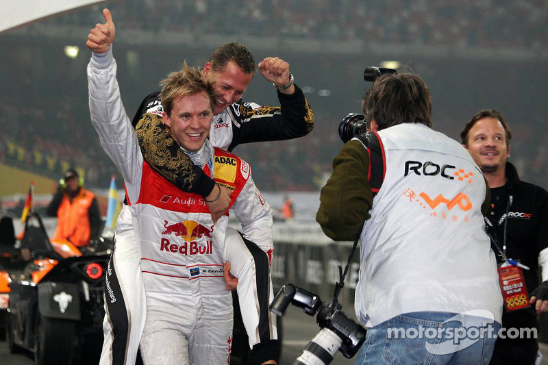 Race of Champions winner Mattias EkstrÃ¶m celebrates with Michael Schumacher