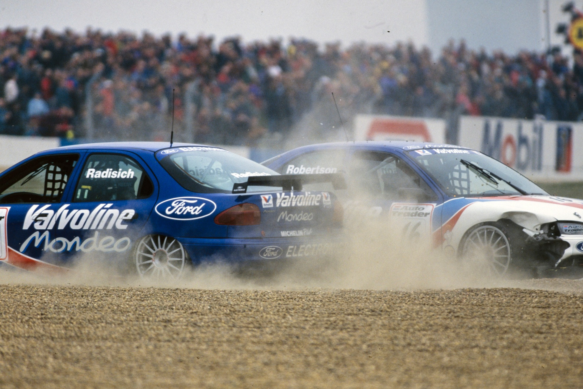 Paul Radisich and Ford team-mate Steve Robertson clash in the 1996 BTCC Donington opener