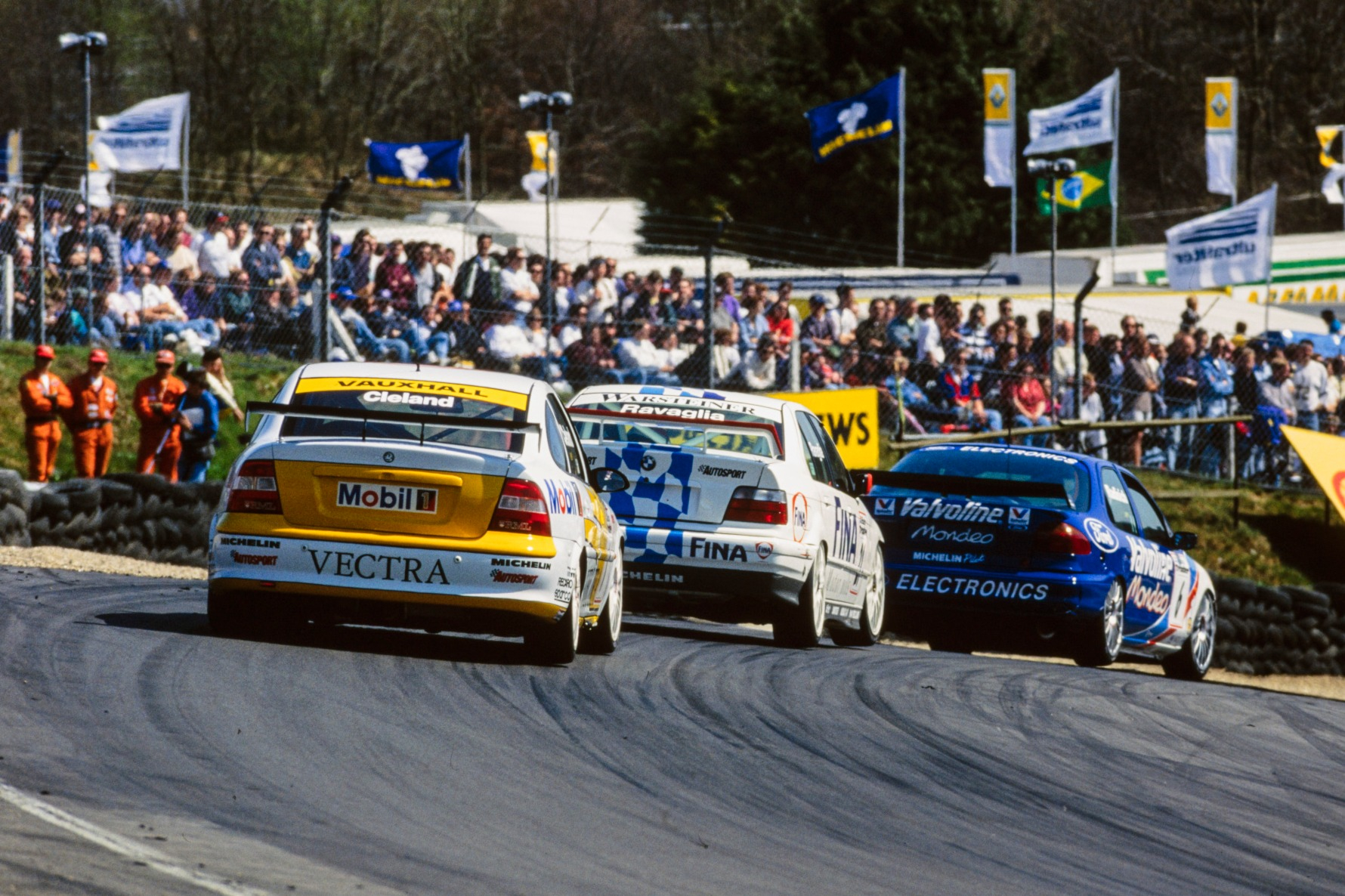 Paul Radisich is chased into Paddock Hill Bend by Roberto Ravaglia's BMW and John Cleland's Vauxhall, Brands Hatch 1996