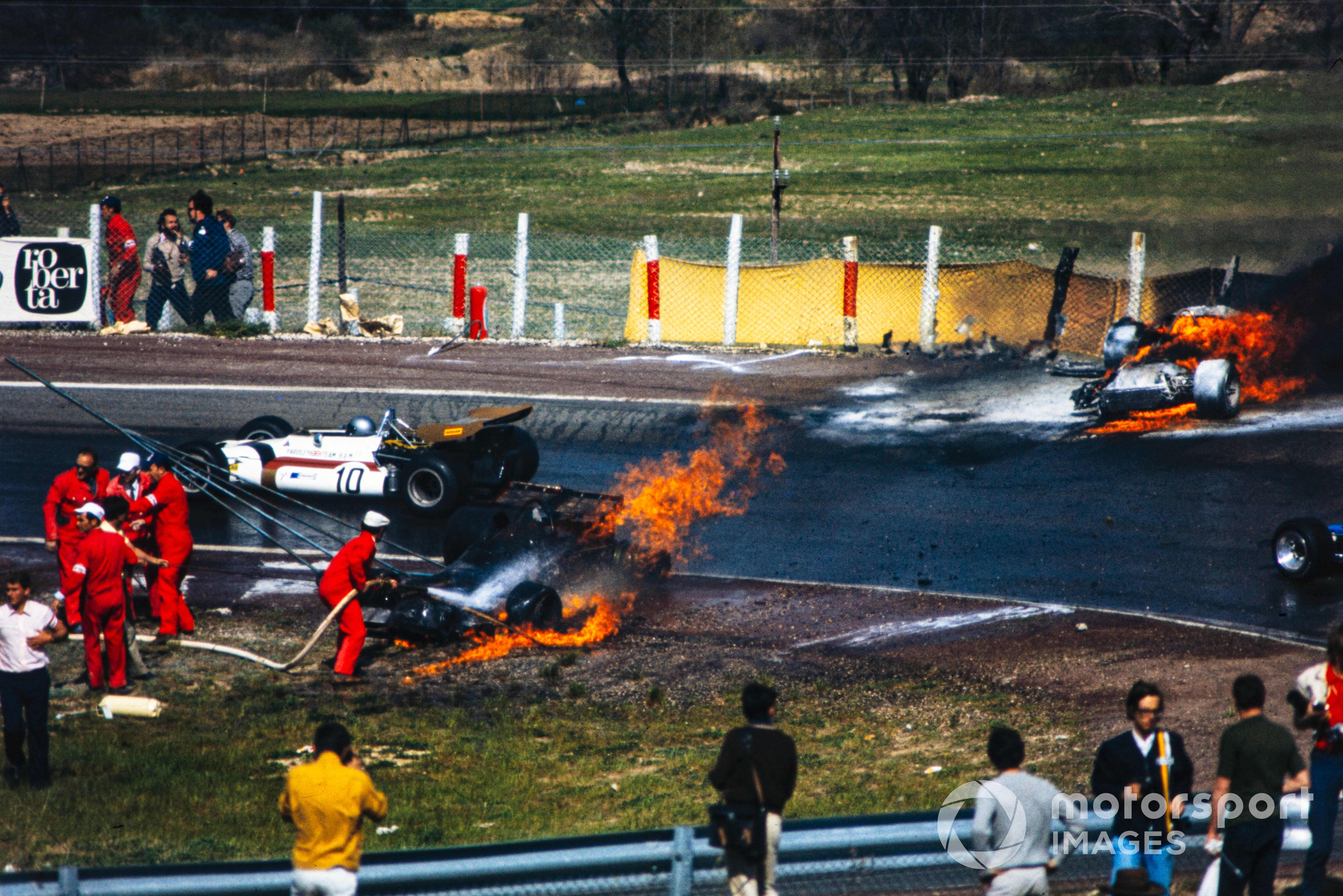 The burning wreckage of Jackie Oliver's BRM and Jacky Ickx's Ferrari at the 1970 Spanish GP