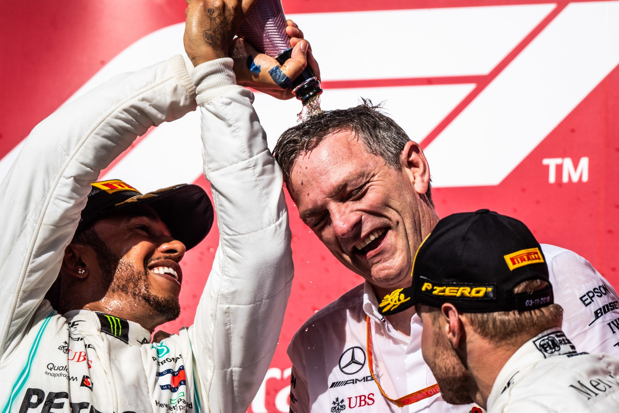 Hamilton douses Allison in champagne after clinching the 2019 title at the US GP