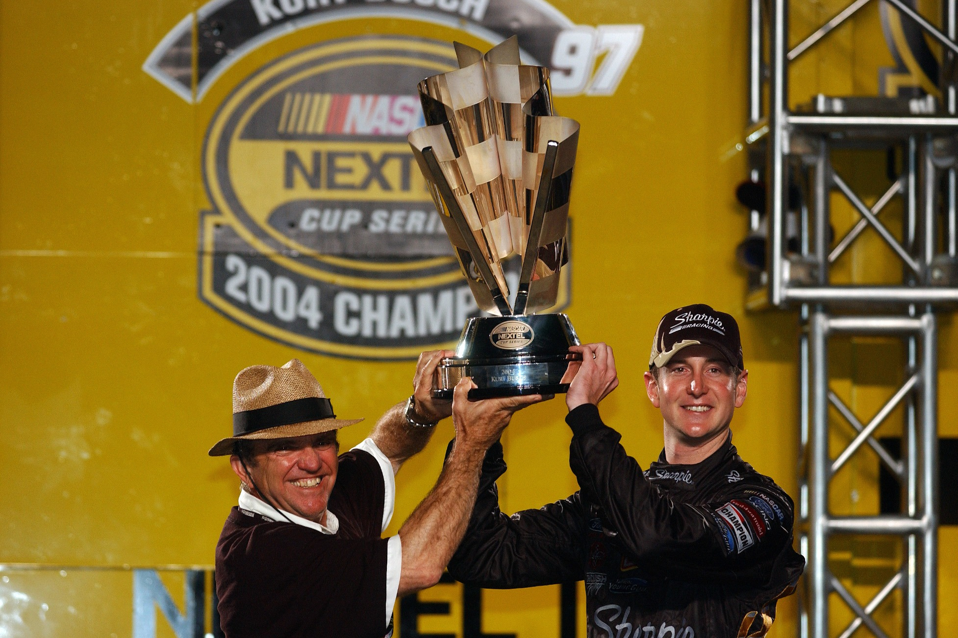 Jack Roush and Kurt Busch hoist the 2004 Cup Series title